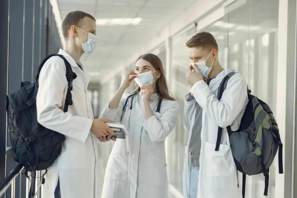 student doctors have discussion with masks on